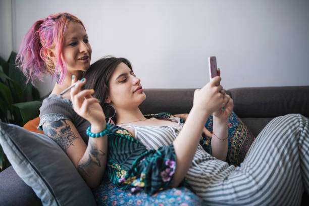Lesbian couple relaxing at home.